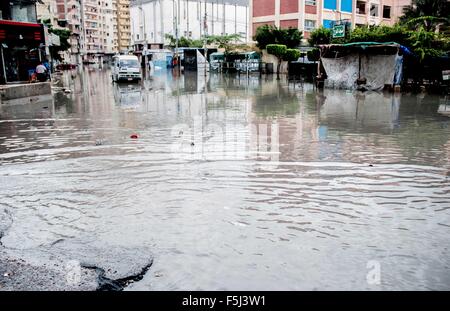 Alexandria, Alexandria, Egypt. 5th Nov, 2015. Egyptians stand in a flooded road following heavy rain storm, in Alexandria, Egypt, November 5, 2015. Eleven people were killed in floods in Beheira province north of Cairo, a security source said, and authorities evacuated 100 people from a village in the province as Egypt suffers from a second round of stormy weather in less than a month Credit:  Amr Sayed/APA Images/ZUMA Wire/Alamy Live News Stock Photo