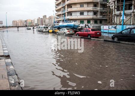 Alexandria, Alexandria, Egypt. 5th Nov, 2015. Egyptians walk in a flooded road following heavy rain storm, in Alexandria, Egypt, November 5, 2015. Eleven people were killed in floods in Beheira province north of Cairo, a security source said, and authorities evacuated 100 people from a village in the province as Egypt suffers from a second round of stormy weather in less than a month Credit:  Amr Sayed/APA Images/ZUMA Wire/Alamy Live News Stock Photo