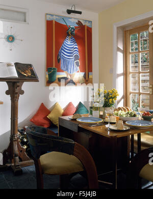 Colourful picture above table set for lunch in nineties dining room witn ecclesiastical style wooden lecturn Stock Photo