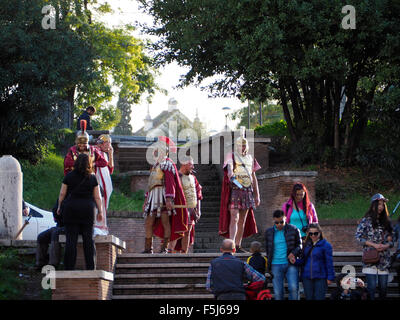 Roman legionaires making a living by having their picture taken together with tourists near the Colosseum, Rome, Italy Stock Photo