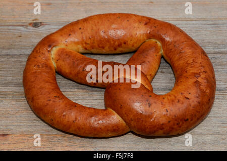 ruddy fresh pretzel on a wooden background Stock Photo