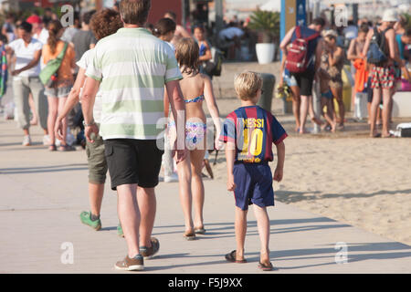 Messi replica Barcelona football kit wearing boy at Barceloneta Beach,urban beach Barcelona,Catalonia,Spain. Stock Photo