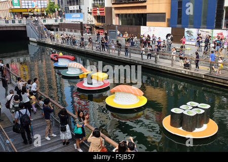 Giant imitation sushi floating along Namba's Dotonbori Canal in Osaka, Japan. Stock Photo