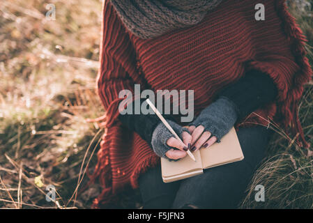 Woman writing in the notebook Stock Photo