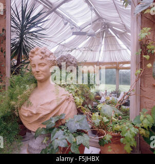 Terracotta bust in an eighties conservatory with white blinds on glass ceiling Stock Photo