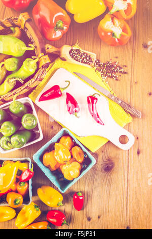 Variety of fresh organic peppers on the table. Stock Photo