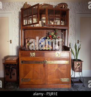 Arts and Crafts dresser in an old fashioned, Edwardian style dining room Stock Photo