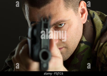 Soldier with rifle AK-47 aiming to you Stock Photo