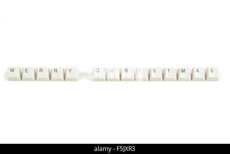 merry christmas text from scattered keyboard keys isolated on white background Stock Photo