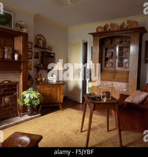 Arts and Crafts dresser and side table in an Edwardian style living room Stock Photo