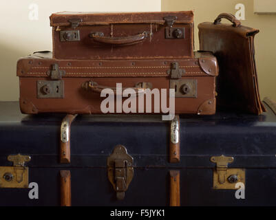 Close-up of a stack of vintage leather suitcases and a large old trunk Stock Photo