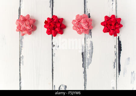 red bows on white wooden background Stock Photo