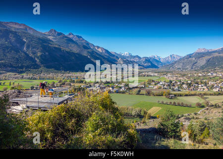 Figure at viewpoint above Durance valley and Mont Pelvoux from Mont-Dauphin Stock Photo