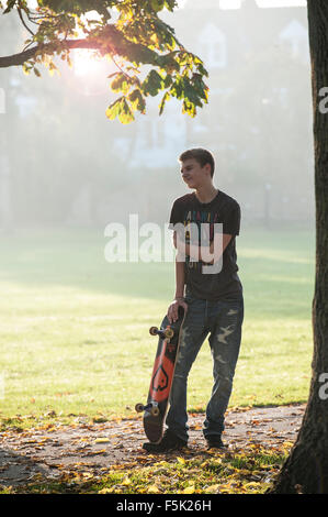 Skateboarding on a sunny autumnal day in a London park Stock Photo