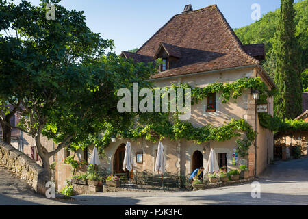 Getting ready to serve breakfast at the cafe, Saint-Cirq-Lapopie, Lot Valley, Midi-Pyrenees, France Stock Photo