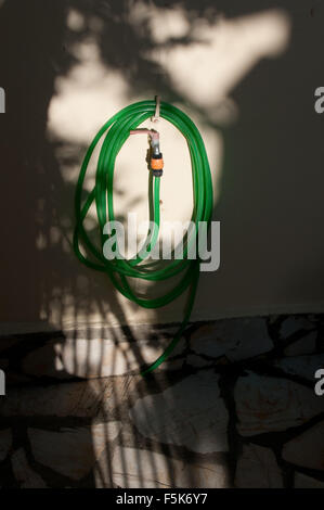 hosepipe on a wall Stock Photo