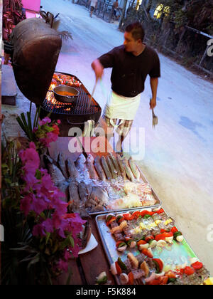 Caye Caulker, Belize. 18th Apr, 2012. A restaurant worker prepares fish on the bbq caught that day at Rose's restaurant. Tourists can pick the fish that they want to have barbecued for dinner. © Julie Rogers/ZUMAPRESS.com/Alamy Live News Stock Photo