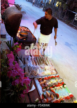 Caye Caulker, Belize. 18th Apr, 2012. A restaurant worker prepares fish on the bbq caught that day at Rose's restaurant. Tourists can pick the fish that they want to have barbecued for dinner. © Julie Rogers/ZUMAPRESS.com/Alamy Live News Stock Photo
