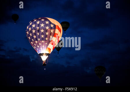 Illuminated Stars and Stripes hot air balloon flying Dawn Patrol, Albuquerque International Balloon Fiesta, New Mexico USA Stock Photo