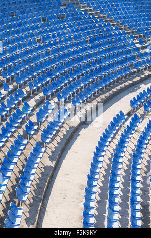 Empty blue chairs in an empty amphitheater hall Stock Photo