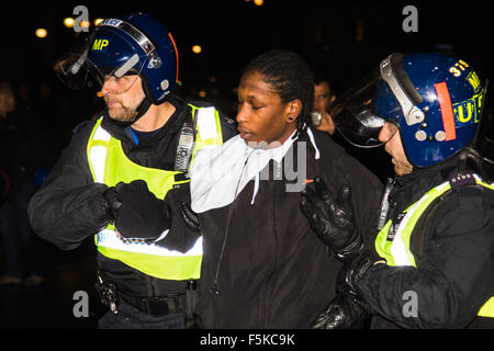 London, UK. 5th November, 2015.   Anarchists and anti-establishment activists hold their annual Million Mask March on Guy Fawkes night, enduring rain and a heavy police presence. The marches origins lie with the online activism group Anonymous. Credit:  Paul Davey/Alamy Live News Stock Photo