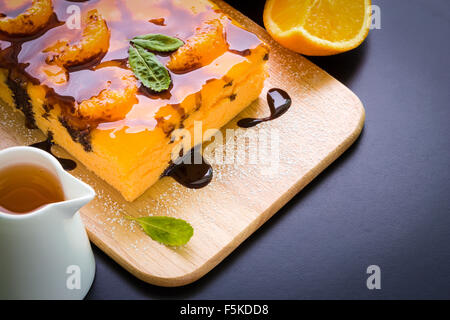 Orange cake with chocolate sauce for tea break. Stock Photo