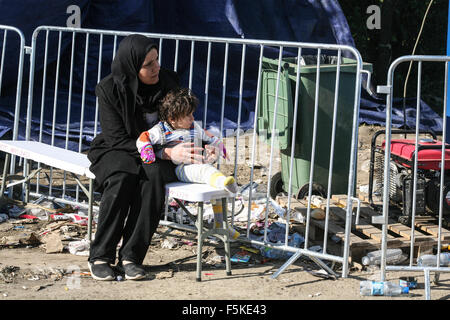 Berkasovo, Serbia. 01st Nov, 2015. A mother holds her child while waiting to cross the Serbian-Croatian border. The United Nations says 210,000 asylum seekers transited through the Balkans in October in an effort to seek protection in Europe. © Luke William Pasley/Pacific Press/Alamy Live News Stock Photo