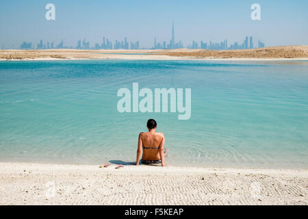 Skyline of Dubai from The Island Lebanon beach resort on a man made island, part of The World off Dubai United Arab Emirates Stock Photo