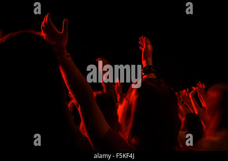 Girl Praising God in Worship With Arms Raised At an Event