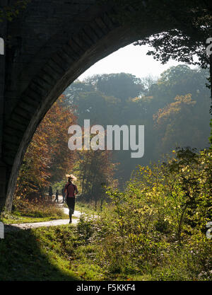 Female jogger running along the riverside path in Durham City, England, UK Stock Photo