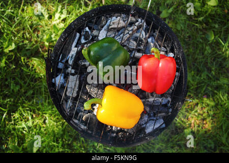 Grilling bell peppers on barbecue grill Stock Photo