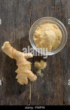 Ginger fresh root and ginger spice on a wooden table Stock Photo
