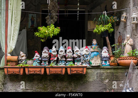 Colourful balcony decorations featuring figurines of snow white and the seven dwarfs and garden gnomes in Montepertuso, Italy Stock Photo