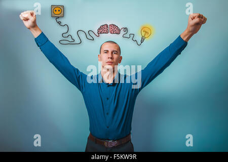 Male businessman raised his hands gesture of victory brain boost Stock Photo