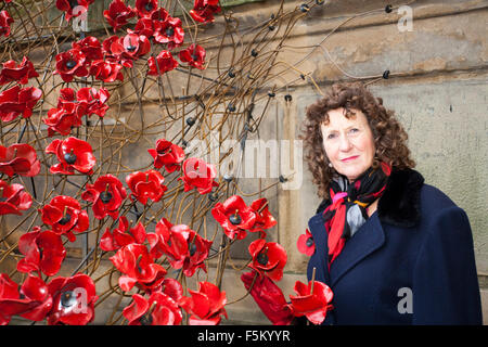 Liverpool, Merseyside, UK. 6th November, 2015. Lyn Newsham who comes from an army family, volunteers as 'The Voice of the City' to describe the installation to visitors.  The 'Weeping Window' poppy installation at St. Georges Hall in Liverpool.  The sculpture has been built by volunteers in commemoration of the fallen heroes of two world wars.  The poppies will be draped like a flowing river, meandering down the steps of St. Georges Hall.  The stunning display will be completed & unveiled for Remembrance Sunday on November 8th. Credit:  Cernan Elias/Alamy Live News Stock Photo