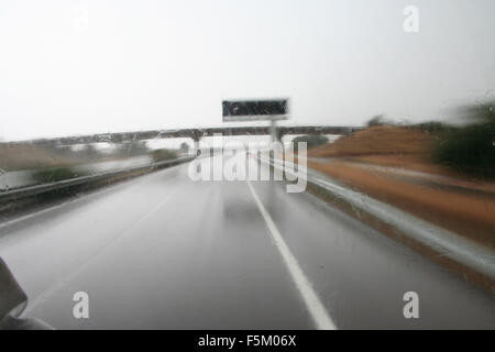 Driving heavy truck  in bad weather conditions by highway. Slow shot Stock Photo