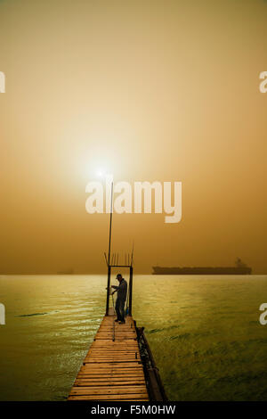 Fisherman on Jetty Stock Photo