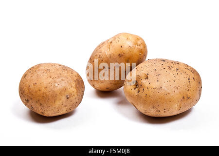 Root vegetables isolated on white. Three potatoes isolated on white background. Stock Photo