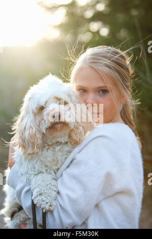 Sweden, Uppland, Lanna, Girl (12-13) holding dog