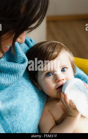 Mother and baby son drinking from bottle Stock Photo