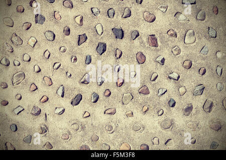 Real stones in cement wall, natural abstract background or texture. Stock Photo
