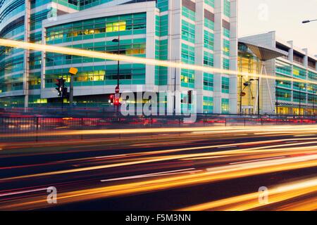 Traffic light trails and office building at dusk, London, UK Stock Photo