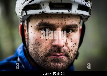 Close up portrait of male mountain biker splashed with mud Stock Photo