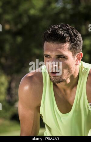 Portrait of sweaty young man training in park Stock Photo