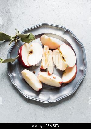 Sliced apple on plate, overhead view Stock Photo