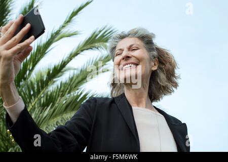 Senior woman taking smartphone selfie Stock Photo
