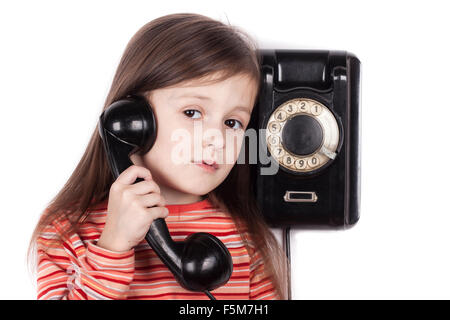 Serious sad child talking on phone isolated, white background Stock Photo