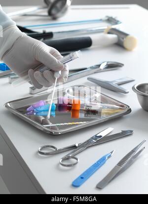 Pathologist taking a sample for analysis during a autopsy Stock Photo ...
