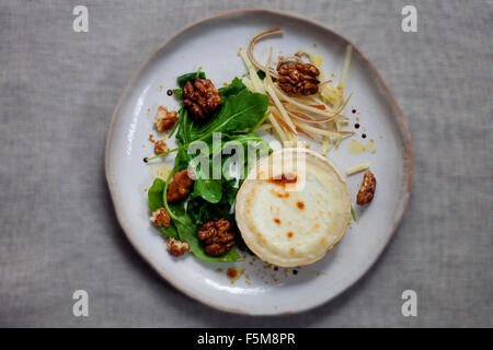 Grilled goat cheese, walnut, apple and rocket salad Stock Photo