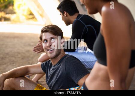 Joggers taking break on bridge Stock Photo